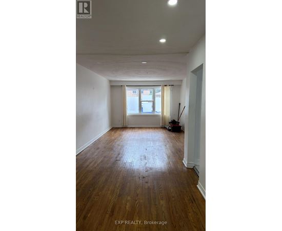 A room with wooden floors and white walls.