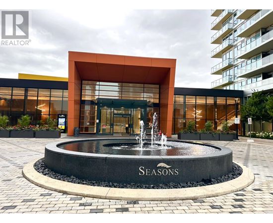 A modern building with a fountain in front of it.