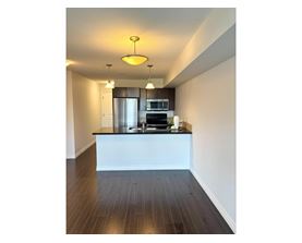 A modern kitchen with a white island and stainless steel appliances.