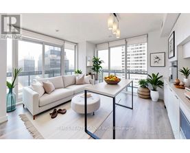 A modern living room with a white sofa, a glass coffee table, and a view of the city.