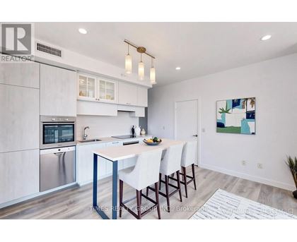 A modern kitchen with a dining table and chairs.