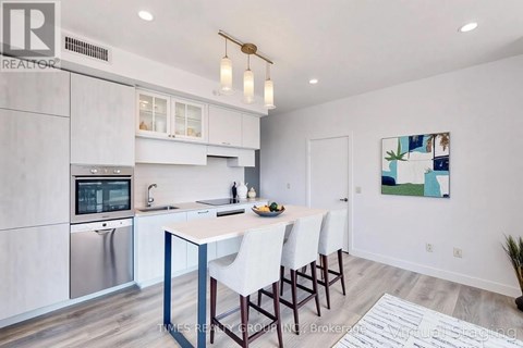 A modern kitchen with a dining table and chairs.