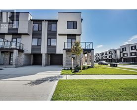 A modern apartment complex with a clear blue sky above.