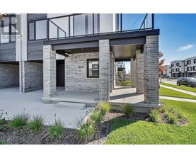 A modern house with a glass door and a brick facade.