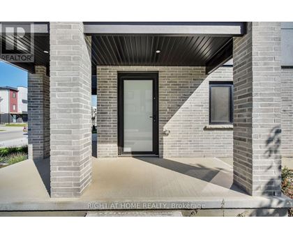 A modern house entrance with a glass door and a brick pillar.