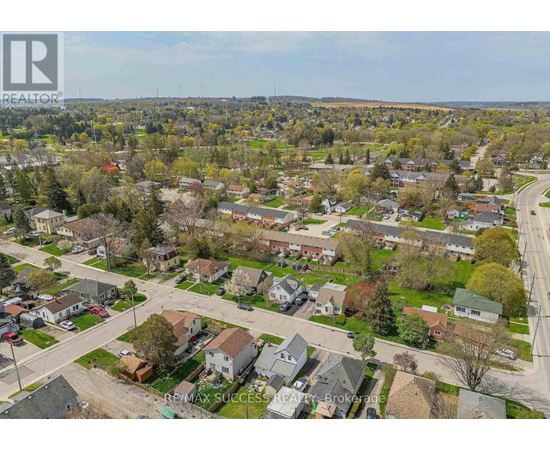 A bird's eye view of a residential neighborhood with houses and trees.
