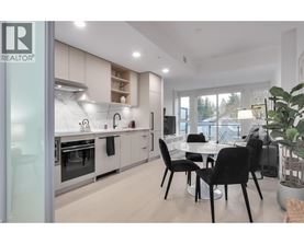 A modern kitchen with a dining table set up.