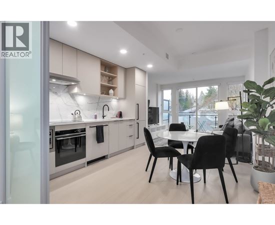 A modern kitchen with a dining table set up.