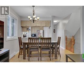 A dining room with a table set for six.