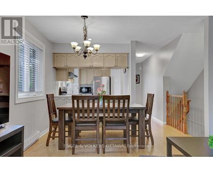 A dining room with a table set for six.