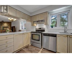A kitchen with wooden cabinets and stainless steel appliances.