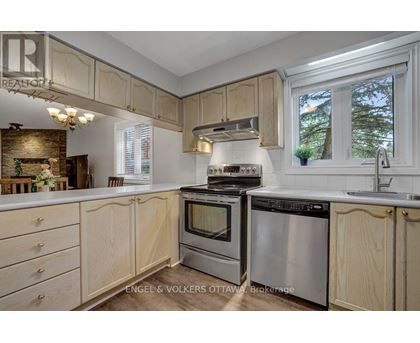 A kitchen with wooden cabinets and stainless steel appliances.