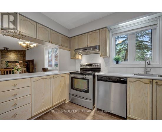 A kitchen with wooden cabinets and stainless steel appliances.