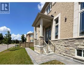 A house with a stone wall and a porch.