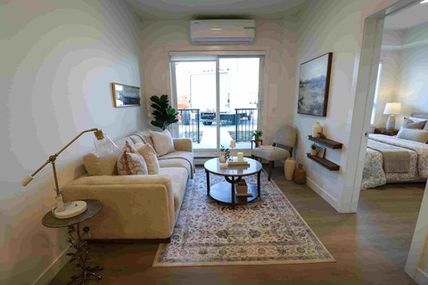 A living room with a white couch and a coffee table.