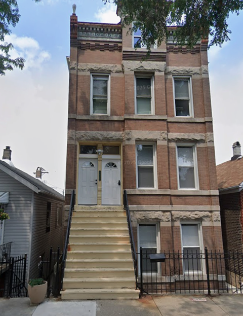 A brown building with a white door and windows.