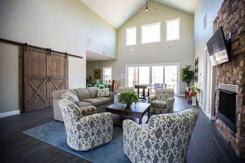 A living room with a fireplace and a large window.