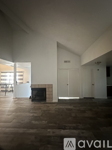 A room with a fireplace and a large window.