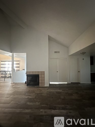 A room with a fireplace and a large window.
