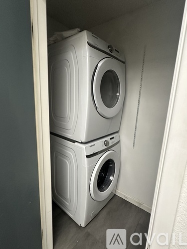 Two washing machines in a small laundry room.