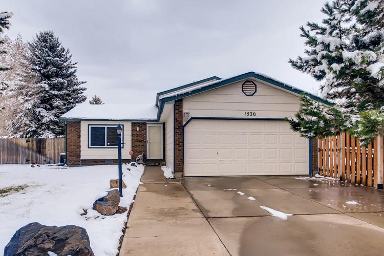 A house numbered 350 with a garage door and a driveway.