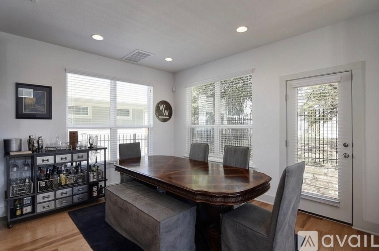 A dining room with a wooden table and chairs.