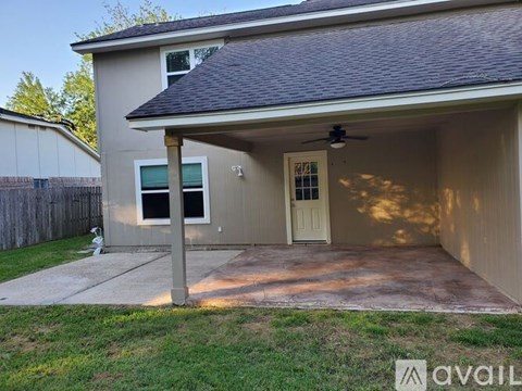 A house with a garage and a fan on the roof.