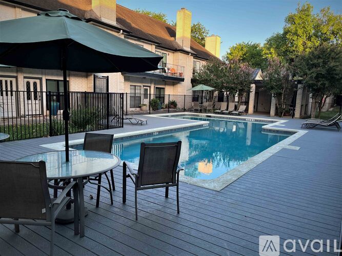 A pool with a table and chairs around it.