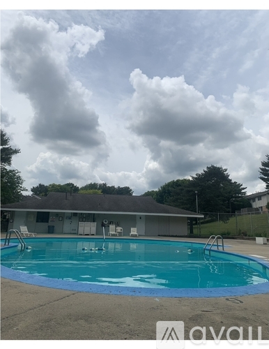 A swimming pool with a cloudy sky in the background.