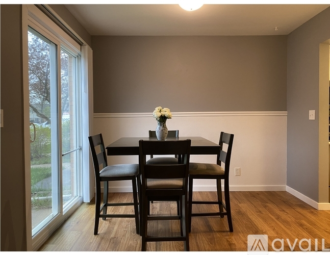 A dining room with a table and chairs.