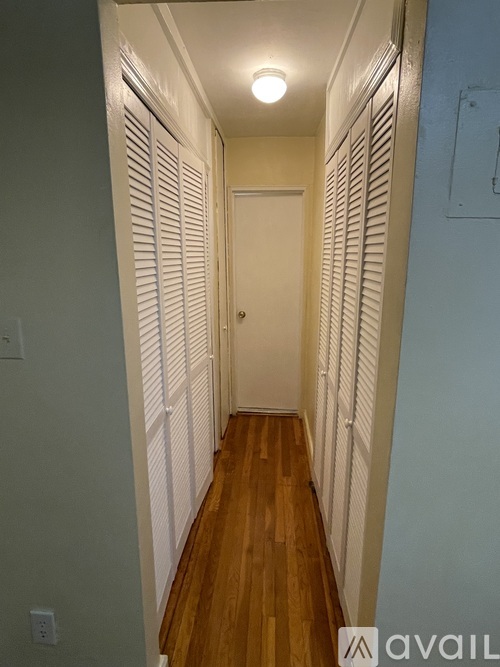 A long hallway with a door at the end.