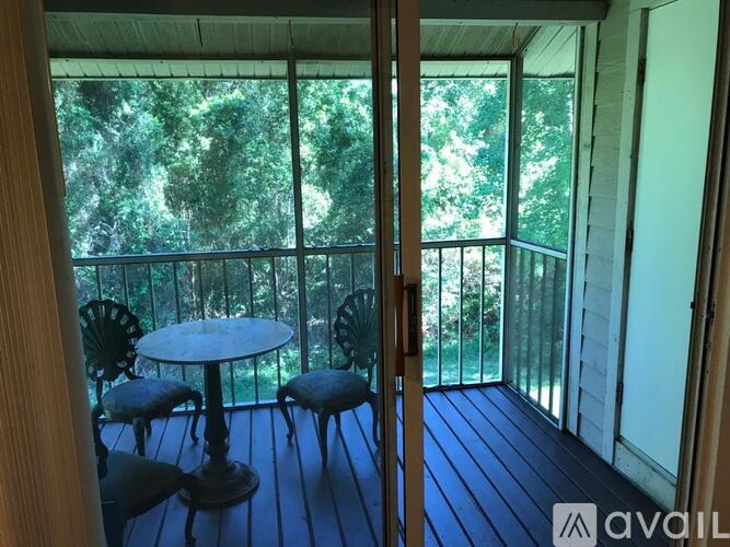 A balcony with a table and chairs is available.