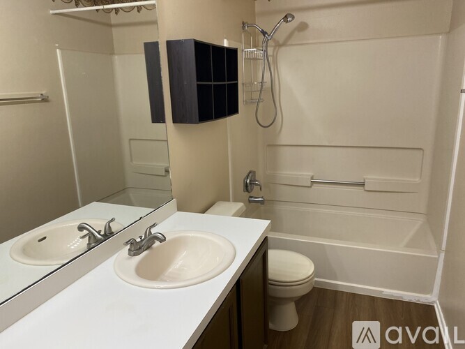 A bathroom with two sinks and a toilet.