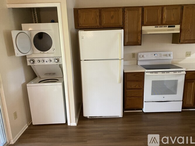 A kitchen with a white fridge and white oven.