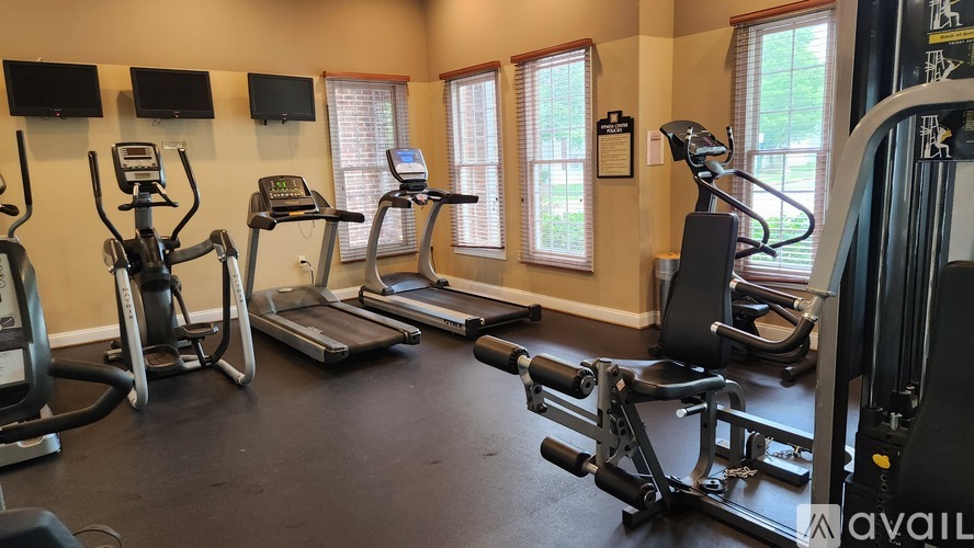 A gym with treadmills, exercise bikes, and other equipment.