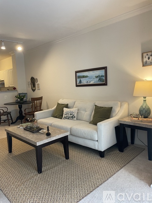 A living room with a white couch and a coffee table.
