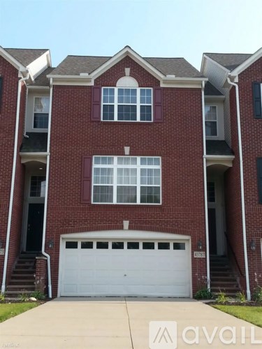 A red brick house with a white garage door.