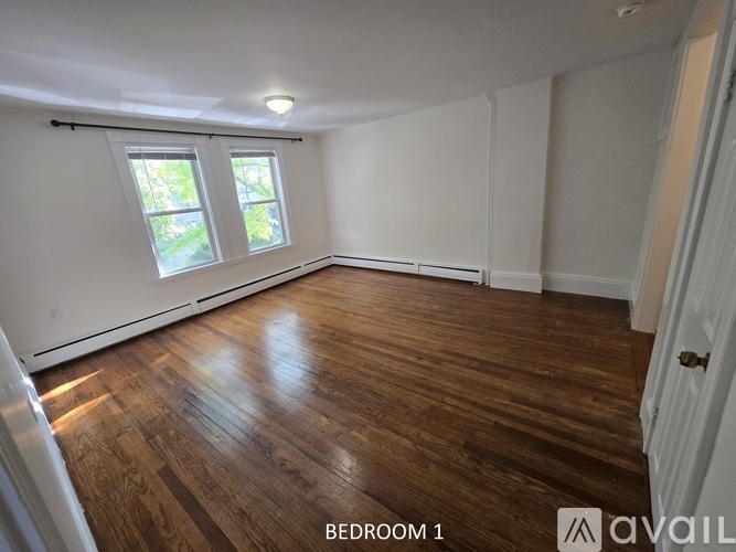 Bedroom 1 has a window with a view of greenery outside.