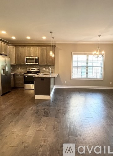 A kitchen with wooden cabinets and a refrigerator.