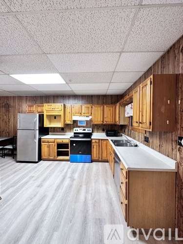 A kitchen with wooden cabinets and a white countertop.