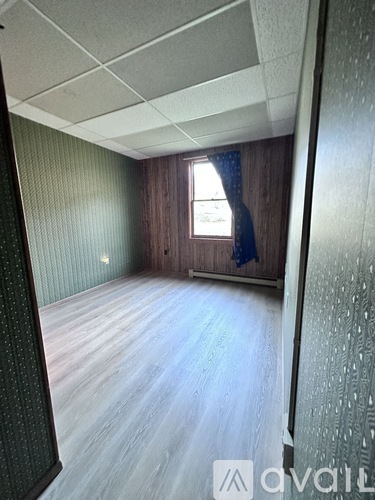 A room with wooden floors and a window.