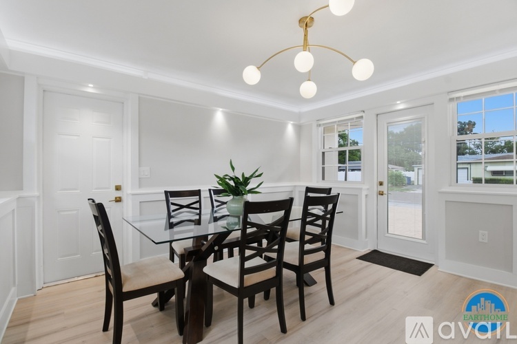 A dining room with a glass table and chairs.