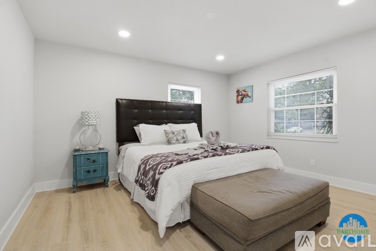 A bedroom with a large bed and a window.