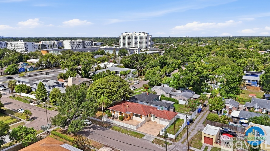 A bird's eye view of a residential area with houses and trees.