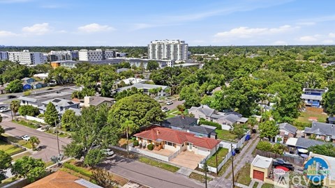 A bird's eye view of a residential area with houses and trees.