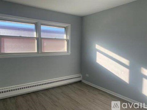 A room with a window and a wall-mounted air conditioner unit.