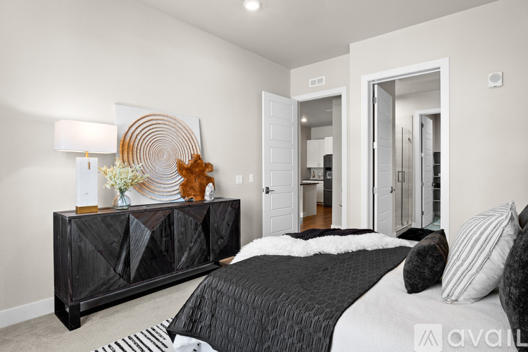 A bedroom with a black and white color scheme and a large bed.