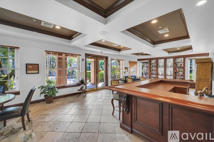 A spacious kitchen with a wooden countertop and a large island.