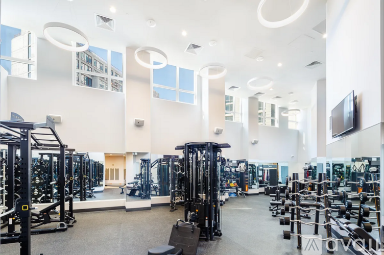 A gym with a variety of equipment including weights and machines.