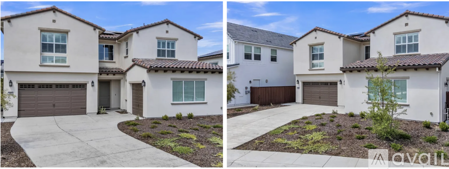 A two-story house with a garage and a driveway.